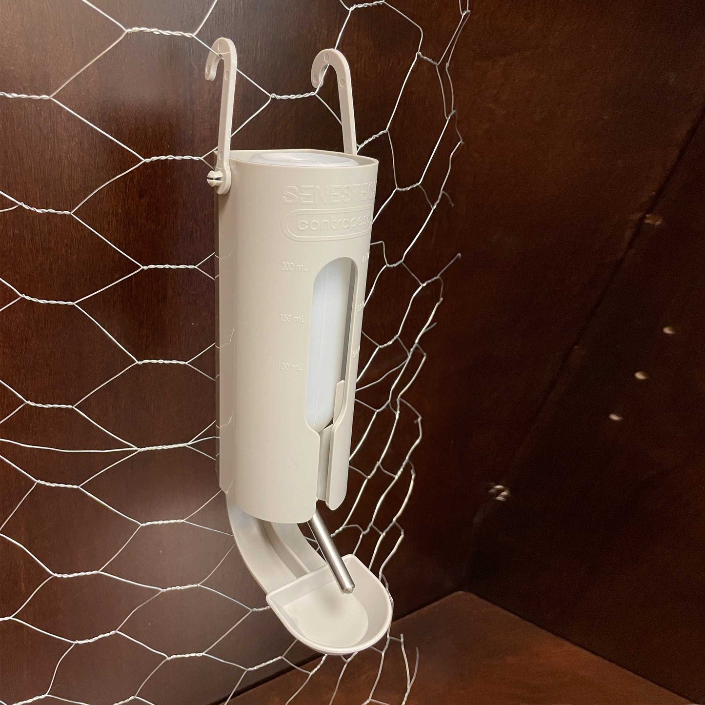 Elevate Bait Station hanging on chicken wire.